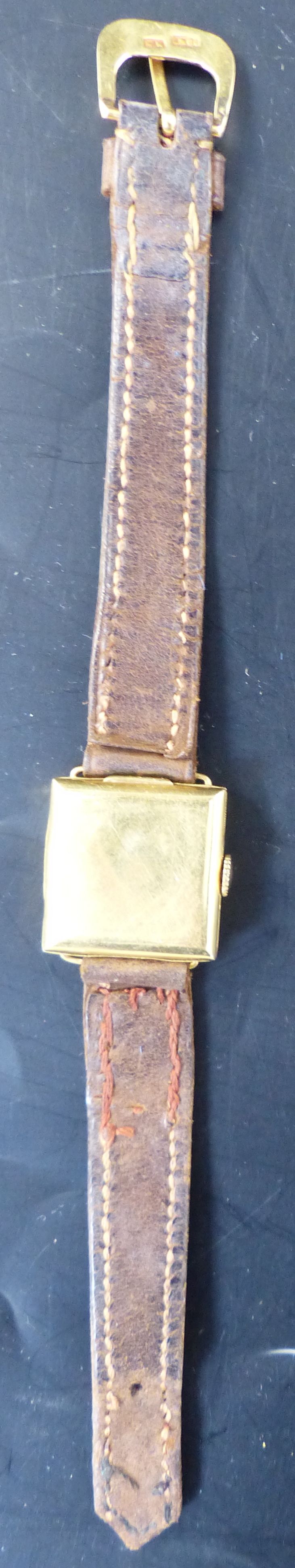 A ladys 1920s 18ct gold square dial wrist watch, 21mm, gross 14.8 grams and a Movado watch